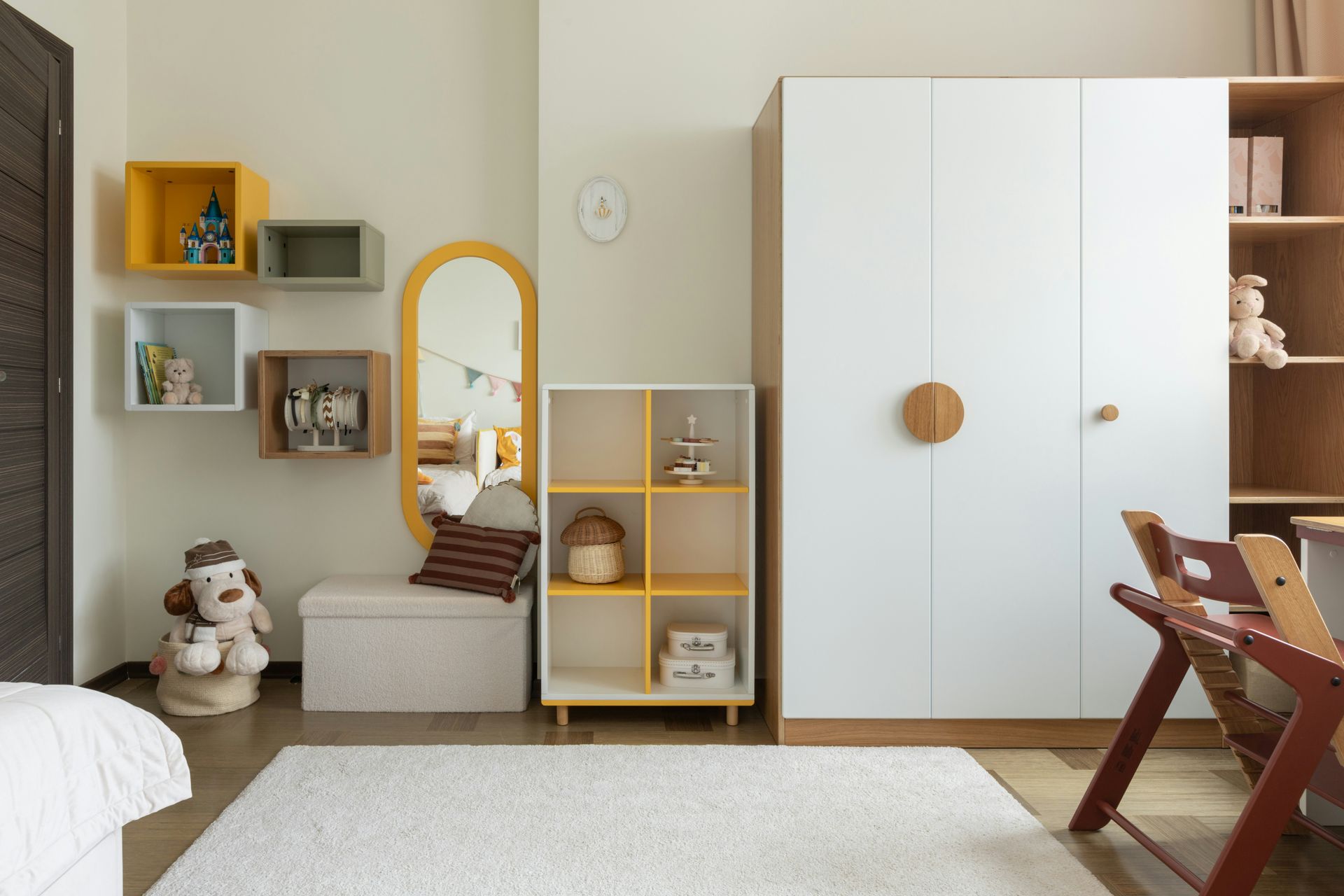 A child's bedroom with white and yellow furniture