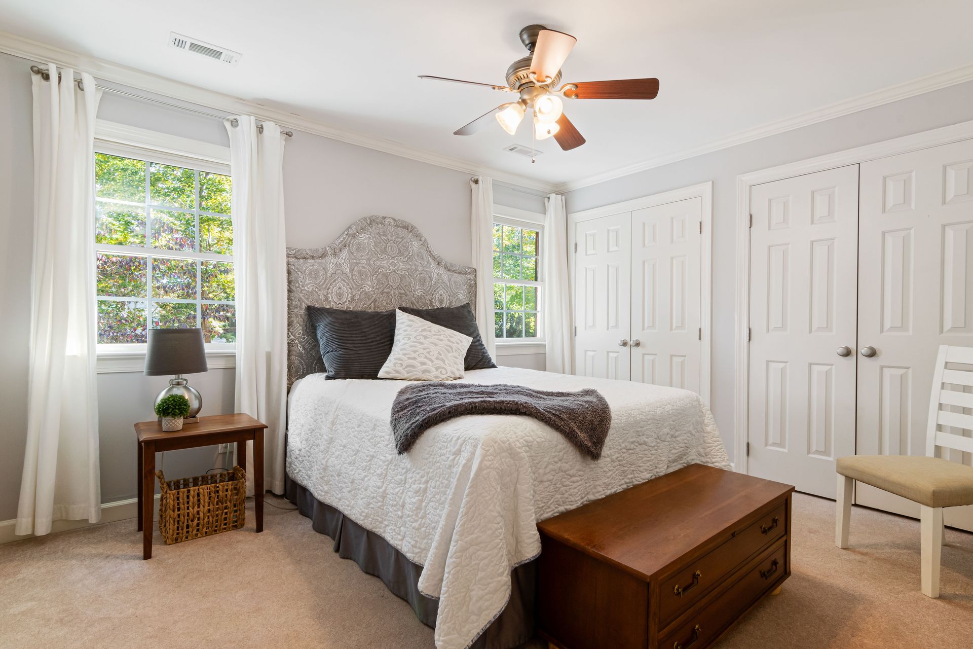 A cozy, well-lit bedroom with modern decor and minimalist furnishings.